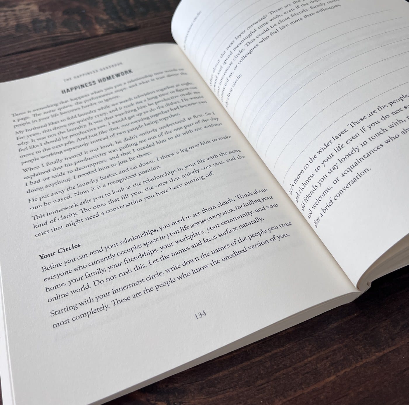 An open spread of The Happiness Handbook: a full page of Happiness Homework writing on the left, and prompts with ruled lines to write your own answers on the right